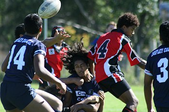 Chifley player gets the ball away despite some brutal defence 