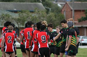 The teams shake hands before the Buckley Shield begins 