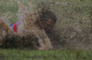 Luke Richmond from the Engadine Dragons slides thru the mud (Photo : ourfooty media)