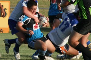 Chuppa Harrison gets smashed as the defence swarm him in the Bulldogs vs Sharks Matty's Cup trial game