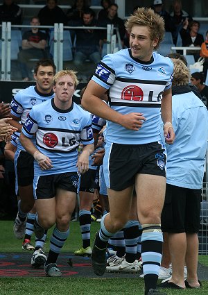 Stewart Mills leads the Cronulla Sharks onto Toyota Stadium (Photo : ourfooty media)