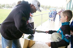 David Peachey signs an autograph for Brodie Christopherson at the regional Peachey Shield carnival at Endeavour Oval.