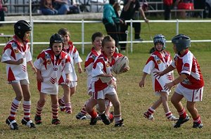 Joshua Dykhoff-Darrington from the Under 7s White takes the ball up to Narooma.