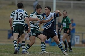 Max Ray takes the ball up for CYMS in the under-18 grand final to Macquarie’s Brodie Chapman in defence.