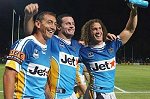 Mat Rogers with his Titan team-mates Chris Walker and Matt Petersen celebrate victory after the NRL trial match between Parramatta and the Gold Coast at Lismore. - Photo: Getty Images