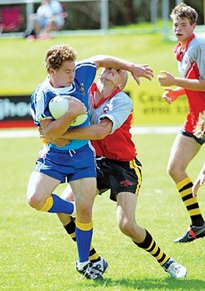 Kurri High’s Luke House shoves a Mount View High defender away during their game in the Coalfields Cup yesterday.