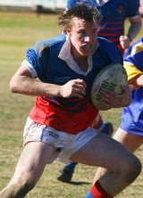 RIVERINA CHAMPIONS: Young High School centre Ryan Kay schemes for an opening against Junee High in YHS’s commanding 30-22 win in the Riverina final of the University Shield at Alfred Oval yesterday. 